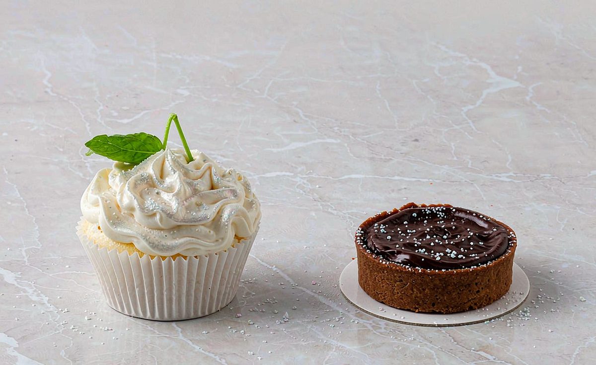 Edible luster dust dusted over a cupcake and a chocolate tart